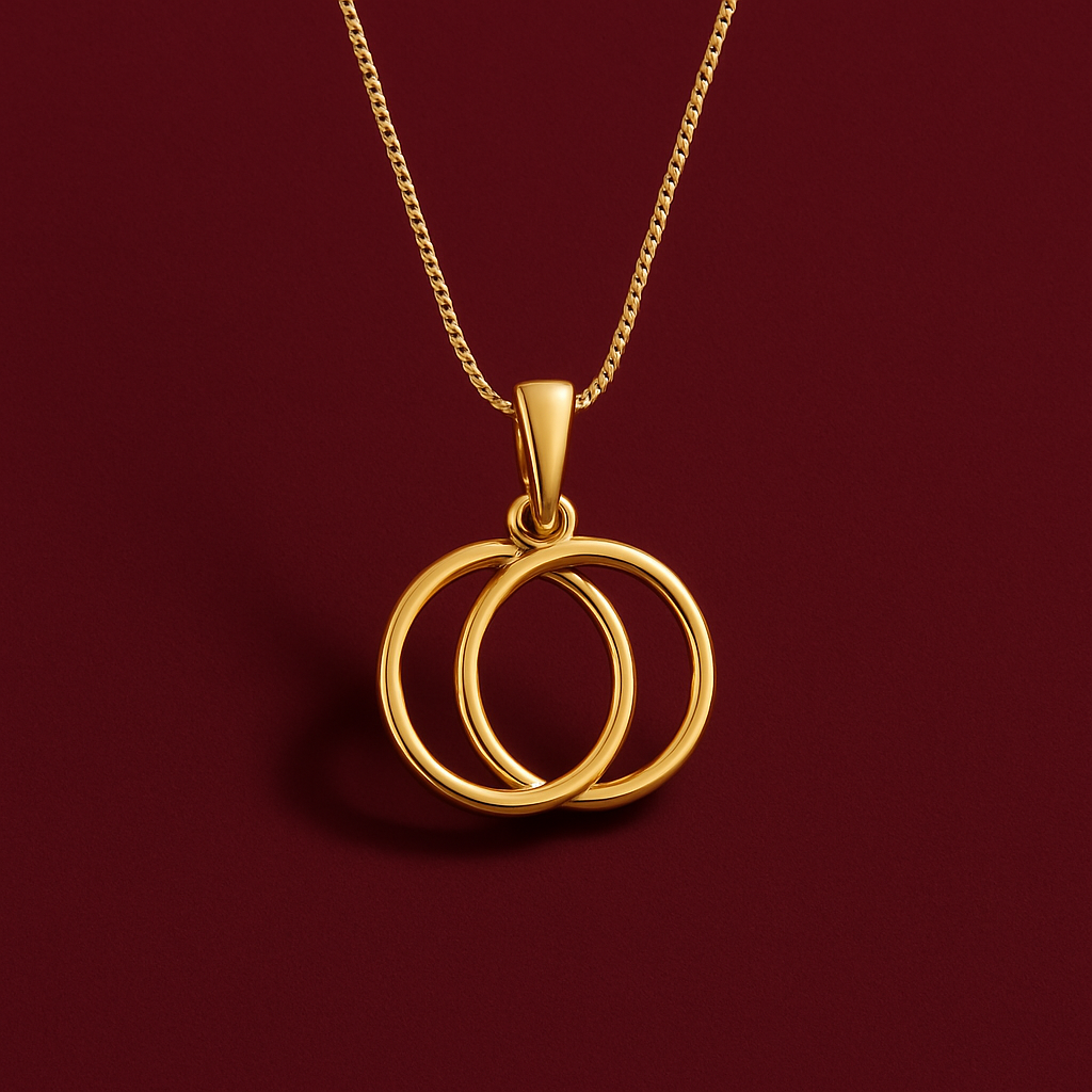 Gold necklace with a double circular pendant on a red background