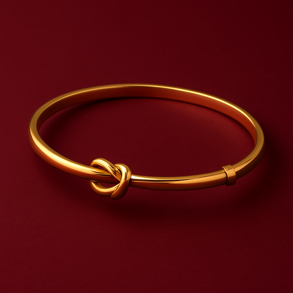 Gold bracelet with a knot design on a red background