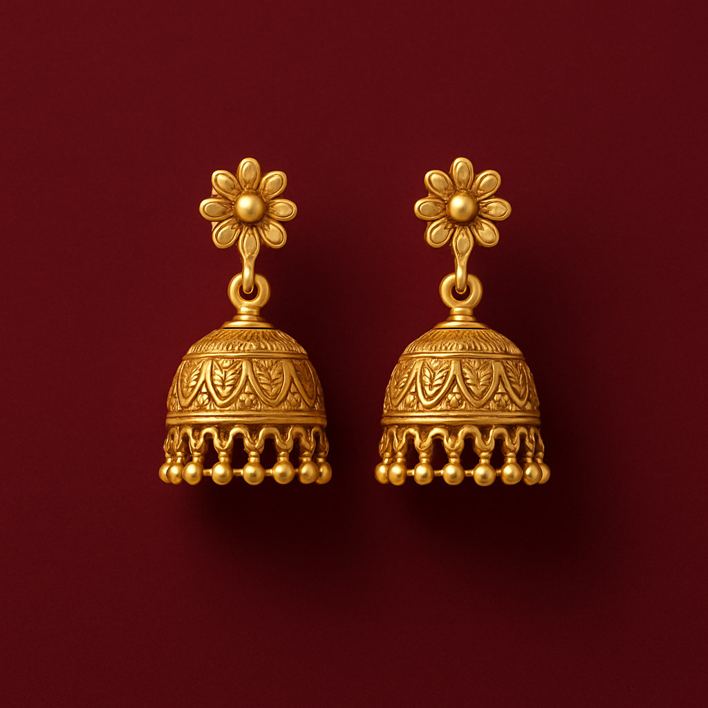 Pair of gold earrings with floral tops on a red background